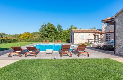 A beautiful stone villa with a swimming pool and a spacious garden