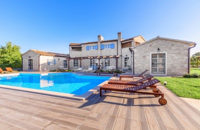A beautiful stone villa with a swimming pool and a spacious garden